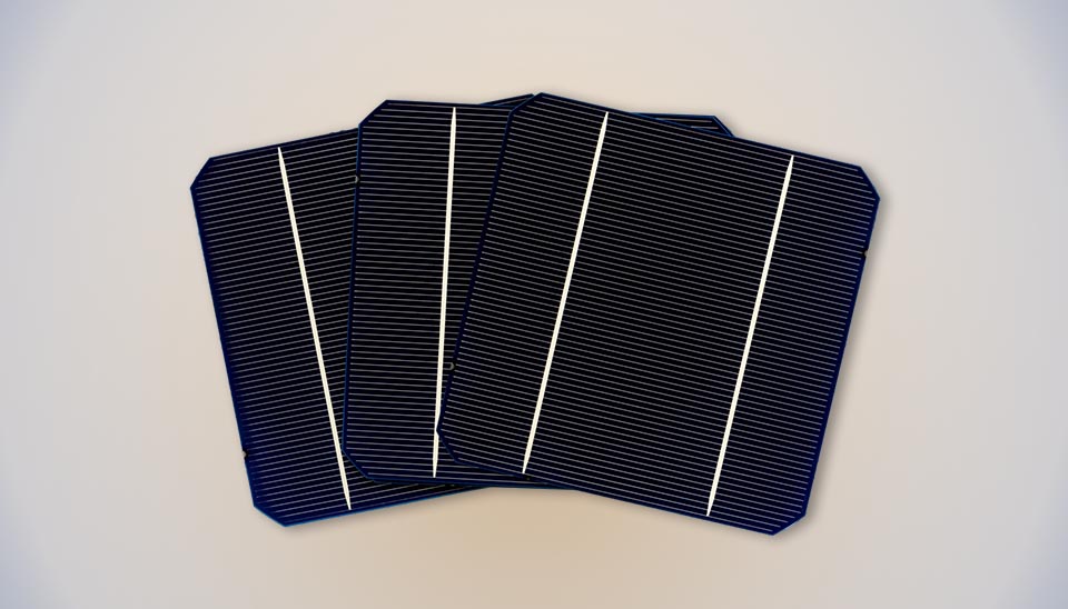 Four overlapping dark blue monocrystalline silicon solar cells with uniform color and distinctive rounded corners.
