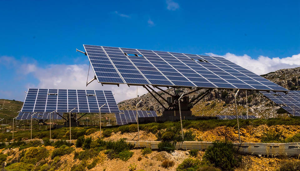 Advanced Altitude-Azimuth dual-axis solar tracking system installation maximizing energy output in a mountainous terrain.