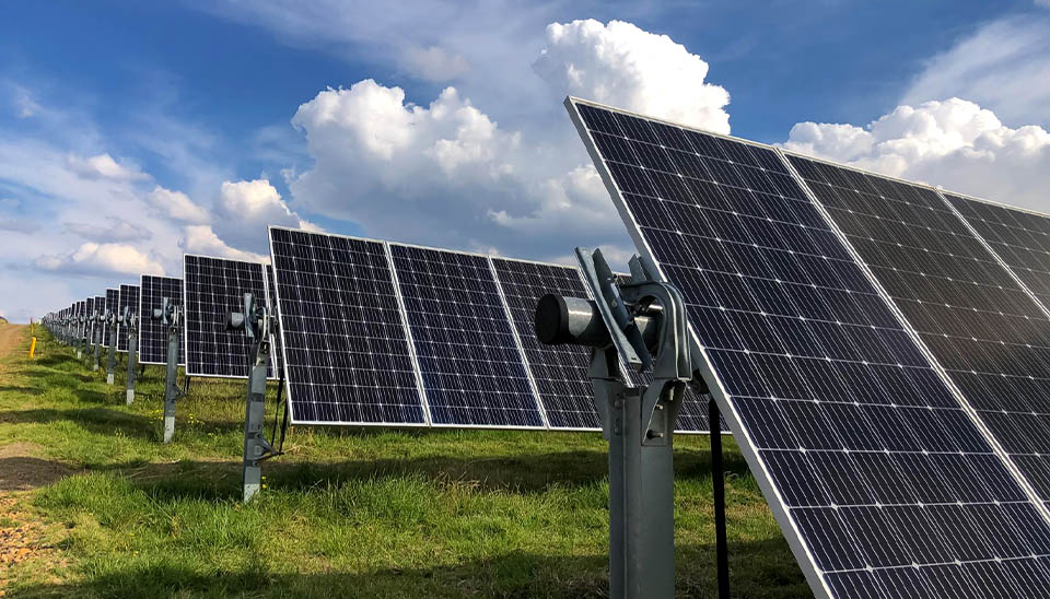 Industrial-scale single-axis solar tracking system adjusting the tilt of PV panels in a solar farm for optimized energy yield.